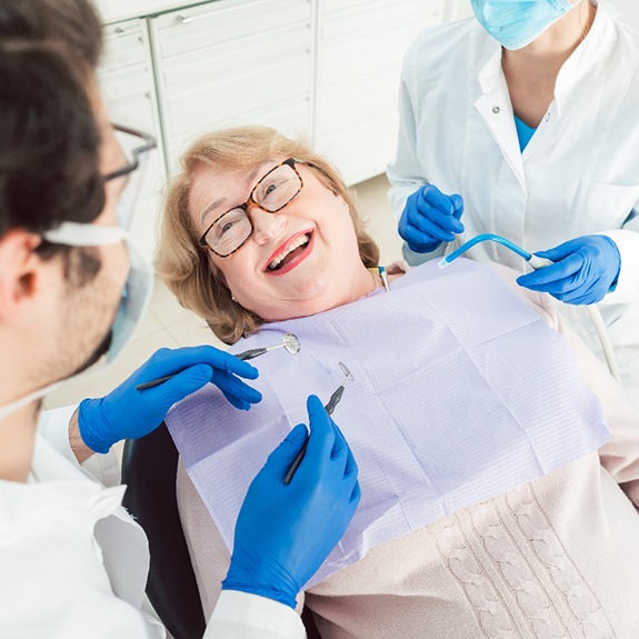 Woman smiling at dentist during exam