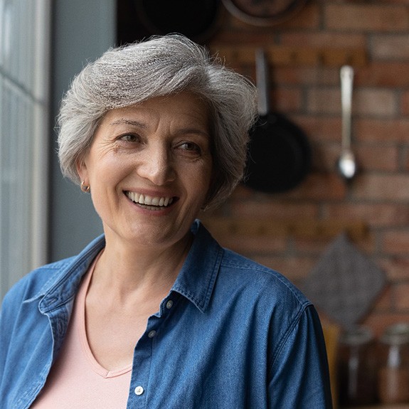 Woman smiling by a window